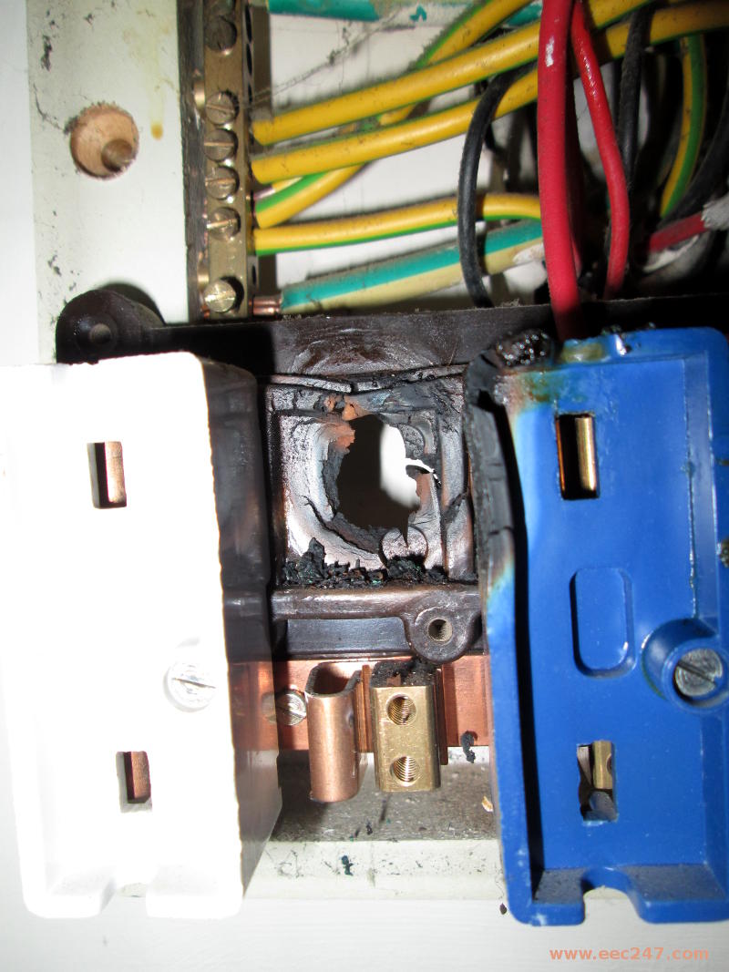 Closeup of a real customers fusebox showing signs of starting a fire