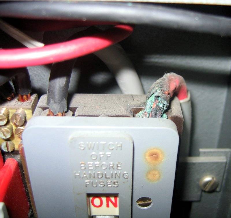 Burned out live cable to main switch inside a 1960s fusebox