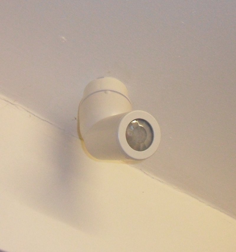 Ceiling mounted motion sensor trained on the kitchen sink