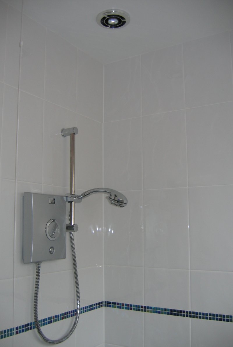 A Bathroom with electric shower and ducted in-line fan with low voltage downlighter