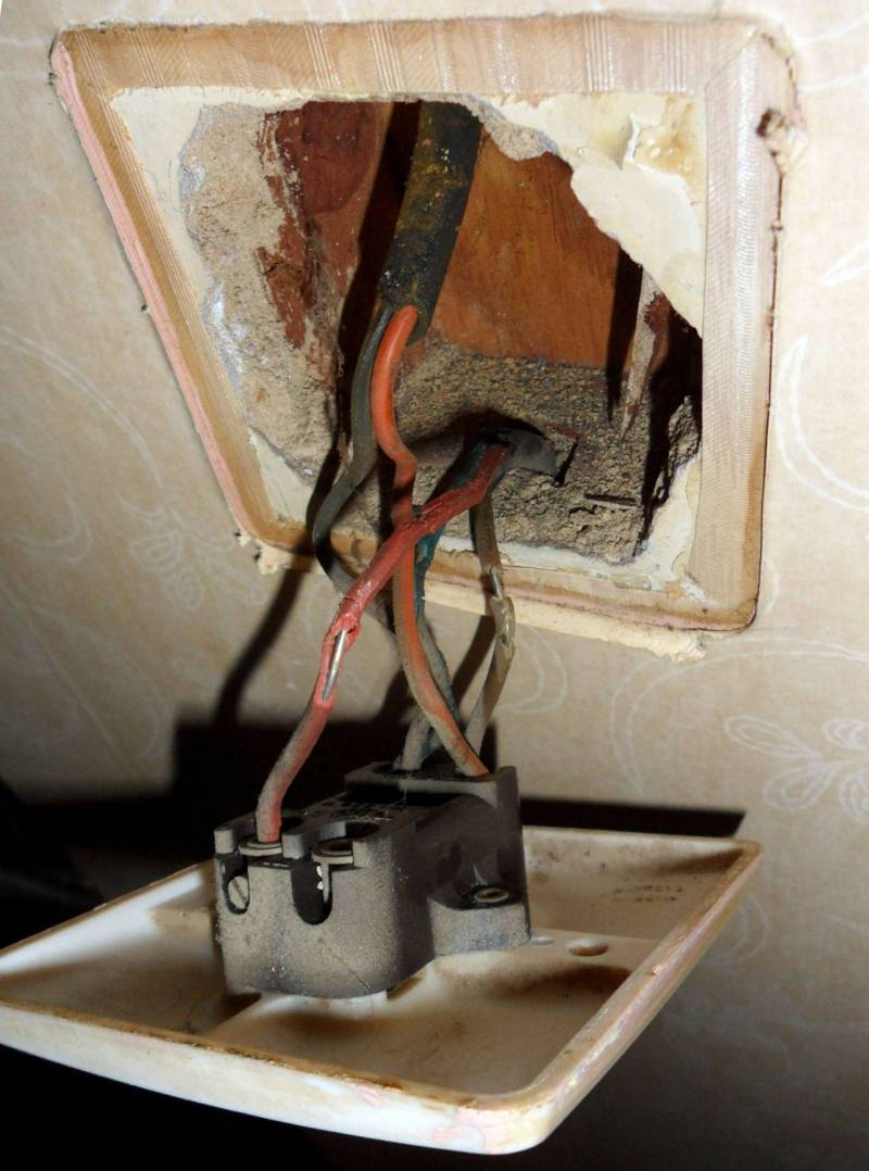 An original 1950s light switch, showing crumbling rubber insulation