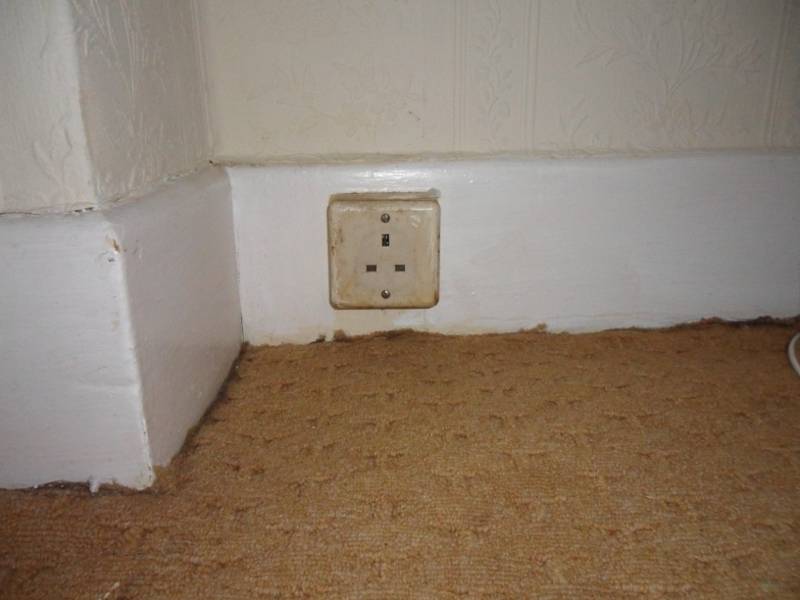 13A socket fixed to the skirting board in a 1950s house