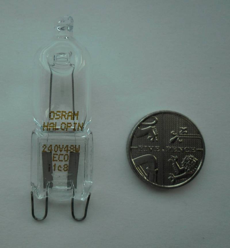 photograph of a halogen G9 capsule compared to a 5p coin